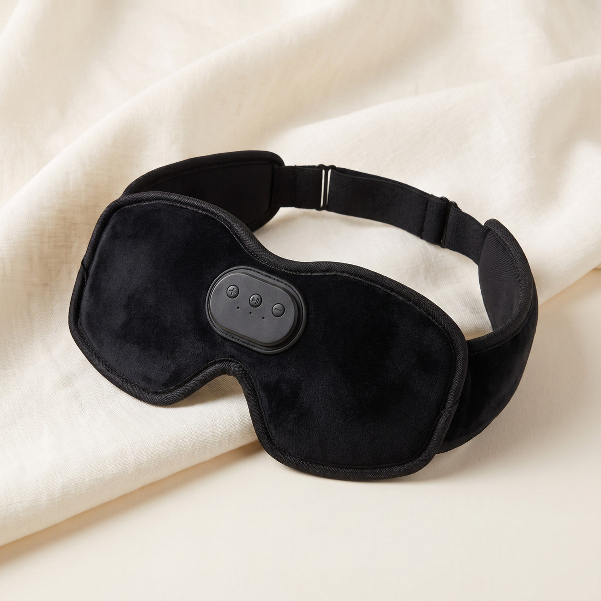 Le masque de sommeil à écouteurs Dorlotte, en velours noir, avec ses boutons au centre